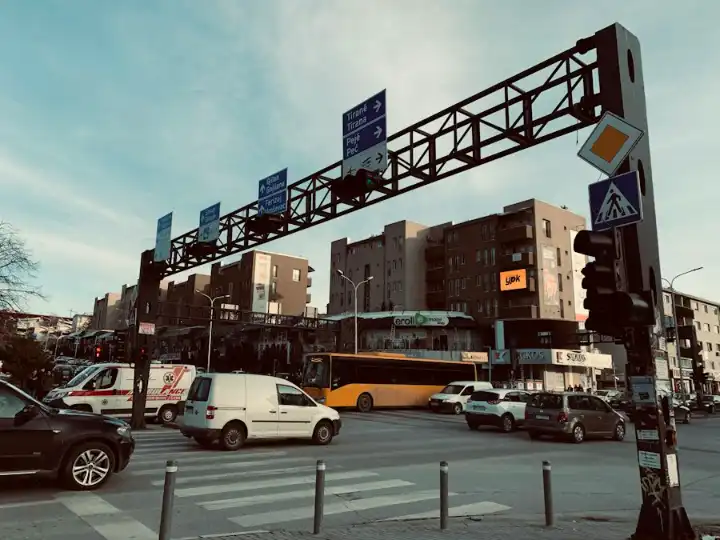 A street in central Prishtina with traffic signs and buses